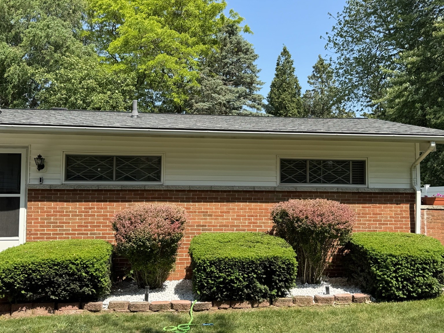 Manicured shrubs and brick home landscaping